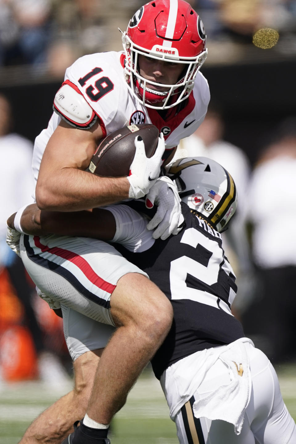 Georgia tight end Brock Bowers (19) is tackled by Vanderbilt defensive back Jaylen Mahoney (23) after a catch in the first half of an NCAA college football game Saturday, Oct. 14, 2023, in Nashville, Tenn. (AP Photo/George Walker IV)