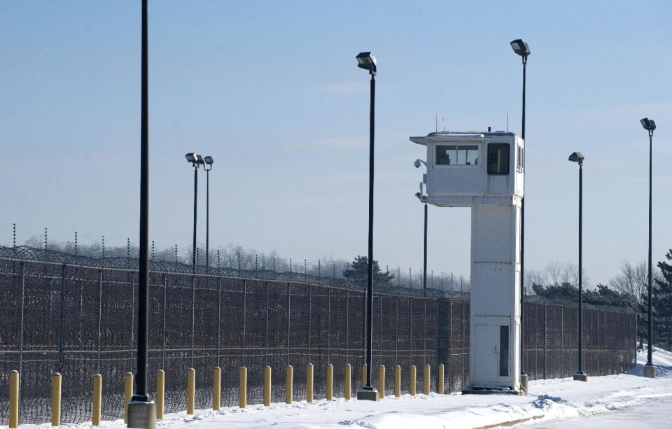 A guard tower stands over fencing at the Ionia Correctional Facility Monday, Feb. 3, 2014. A national manhunt is underway for convicted killer Michael Elliot who escaped from the prison on Sunday. (AP Photo/The Grand Rapids Press, Chris Clark) ALL LOCAL TV OUT; LOCAL TV INTERNET OUT