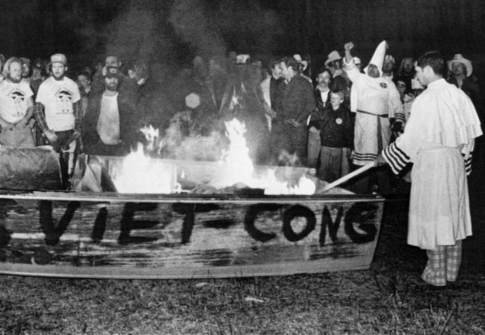 <div class="inline-image__caption"><p>Louis Beam, Grand Dragon of the Texas Realm of the Knights of the Ku Klux Klan, sets fire to a boat labeled “Viet-Cong” during a rally for white Texas Gulf fisherman in Santa Fe, Texas, on Feb. 14, 1981.</p></div> <div class="inline-image__credit">Bettmann Archive/Getty</div>