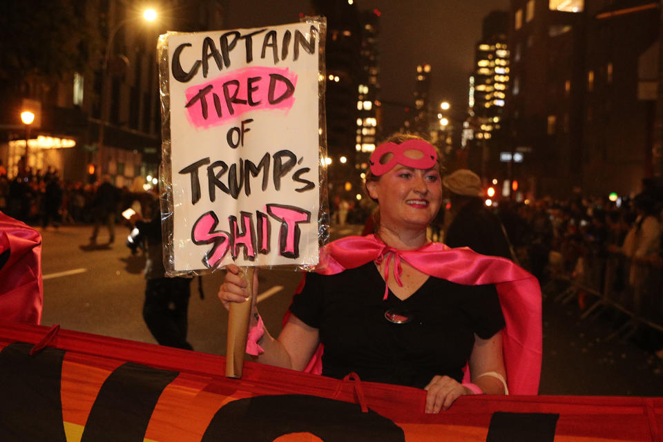 A reveler from "Gays Against Guns: carries an anti-Trump sign while marching in the 46th annual Village Halloween Parade in New York City. (Gordon Donovan/Yahoo News)