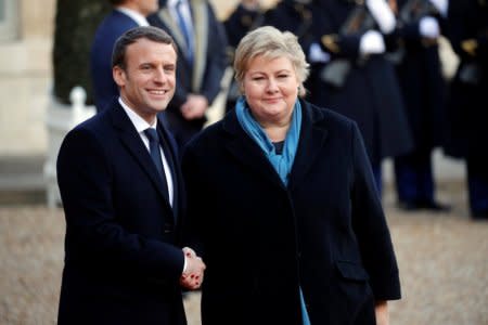 French President Emmanuel Macron welcomes Norway's Prime Minister Erna Solberg for a lunch at the Elysee Palace as part of the One Planet Summit in Paris, France, December 12, 2017. REUTERS/Philippe Wojazer