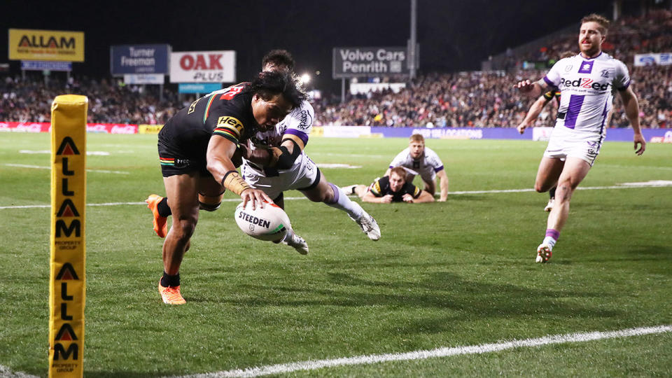 Seen here, Brian To'o scoring a try for Penrith against Melbourne in the NRL. 