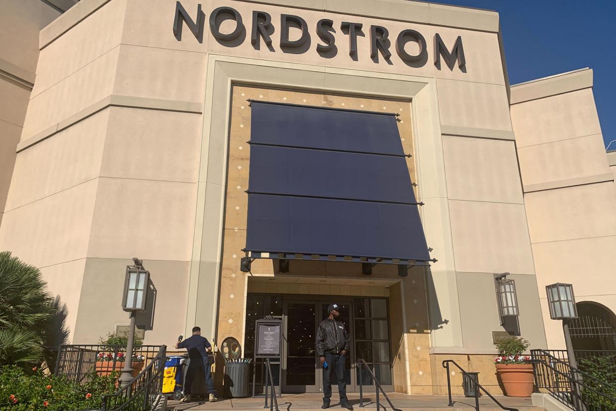 A security guard stands outside the Nordstrom store at The Grove retail and entertainment complex in Los Angeles, Tuesday, Nov. 23, 2021. Los Angeles police say a group of thieves smashed windows at the department store at the luxury mall late Monday, the latest incident in a trend of smash-and-grab crimes is part of a national trend.