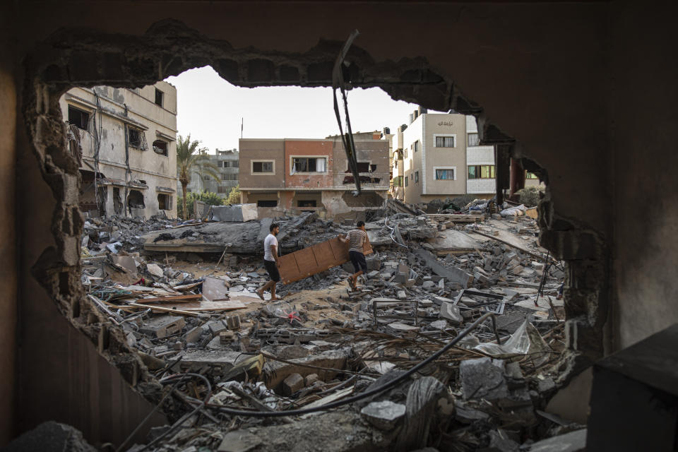 Palestinians inspect their house which was hit by an Israeli airstrike in Gaza City, Monday, Aug. 8, 2022. A cease-fire between Israel and Palestinian militants has taken effect late Sunday in a bid to end nearly three days of violence that has killed dozens of Palestinians. (AP Photo/Fatima Shbair)