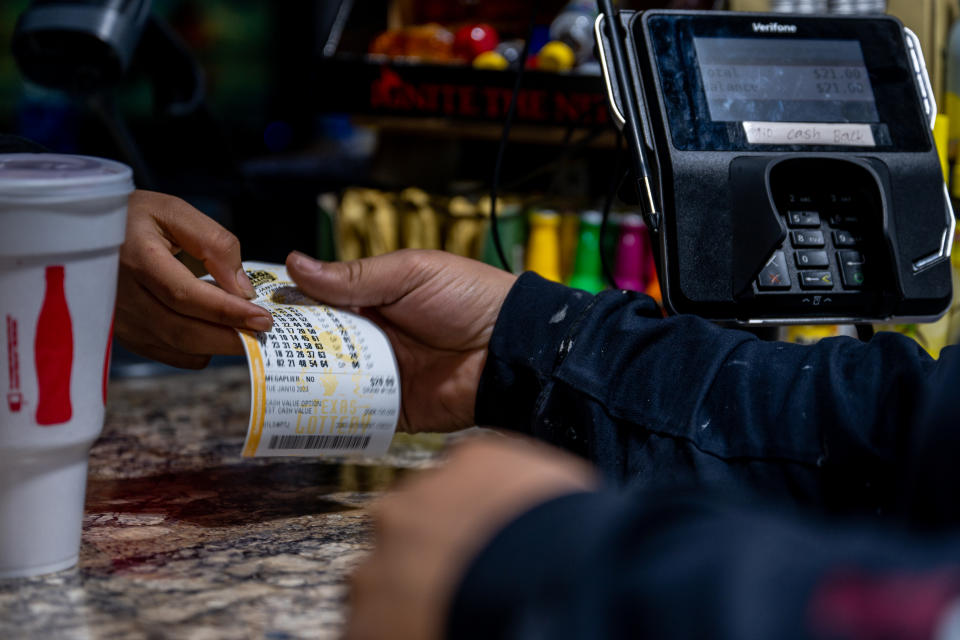 AUSTIN, TEXAS - JANUARY 10: A customer purchases a lottery ticket at a CITGO gas station on January 10, 2023 in Austin, Texas. The Mega Millions jackpot has climbed to $1.1 billion ahead of today's drawing. (Photo by Brandon Bell/Getty Images)