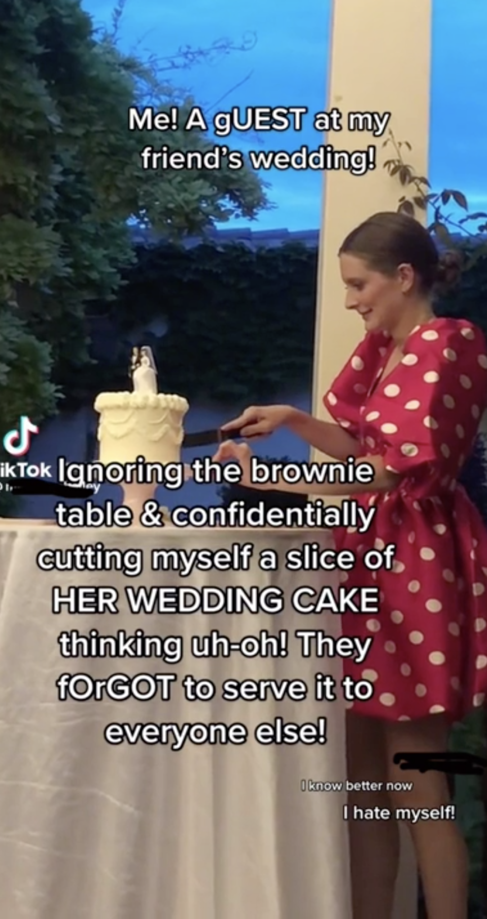 A woman cutting a piece of the bride and groom's cake