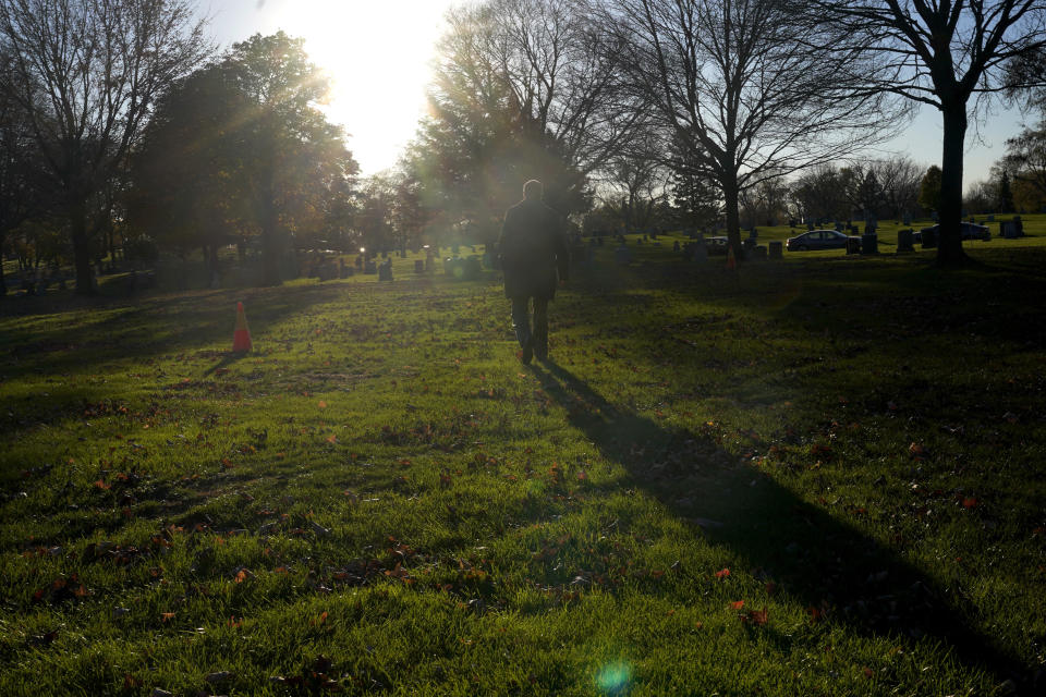 Cook County, Ill., Sheriff's Commander Jason Moran, who leads the sheriff's missing persons initiative walks away from a grave of a person who self-identified as Seven, at the Mount Olivet Cemetery on Chicago's Far South Side Monday, Nov. 13, 2023. Eight years after Seven's death, Moran's office took up the case to identify Seven and through fingerprints taken by the coroner's office, accessing military records, Moran restored their name, Reba C. Bailey, a 75-year-old Illinois veteran missing since the 1970s. (AP Photo/Charles Rex Arbogast)