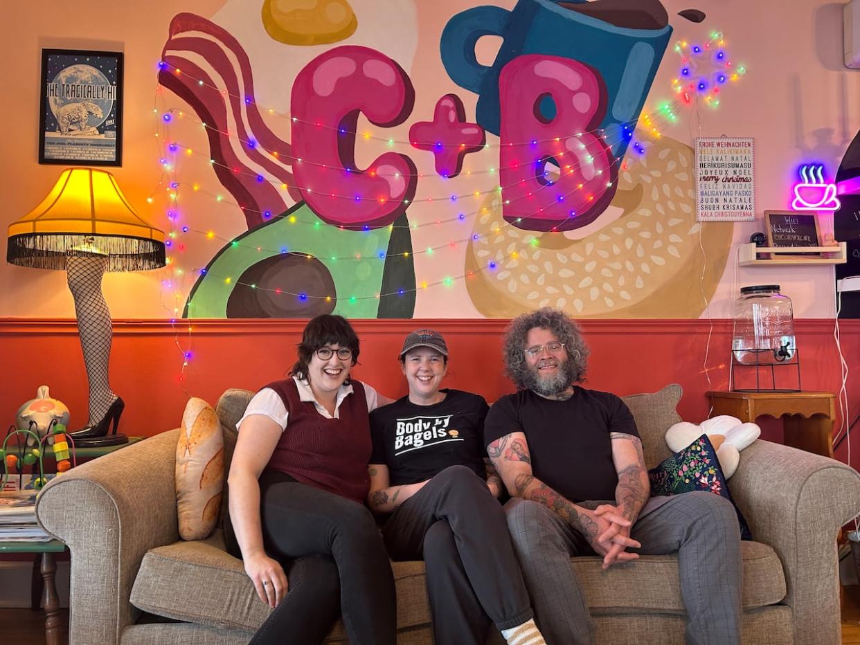 Lindsay Connolly, left, Megan Beairsto, centre, and Edward Lambert are getting set to host a levee New Year's Day from 11 a.m. to 3 p.m.  (Stacey Janzer/CBC - image credit)