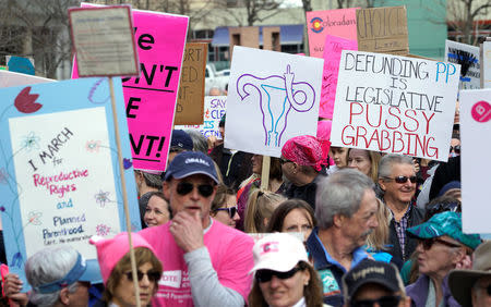 Planned Parenthood supporters hold signs at a protest in downtown Denver February 11, 2017. REUTERS/Rick Wilking