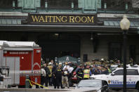 <p>Emergency officials stand outside of the Hoboken Terminal following a train crash, Thursday, Sept. 29, 2016, in Hoboken, N.J. A commuter train crashed into the rail station during the morning rush hour, causing serious damage. (AP Photo/Julio Cortez) </p>