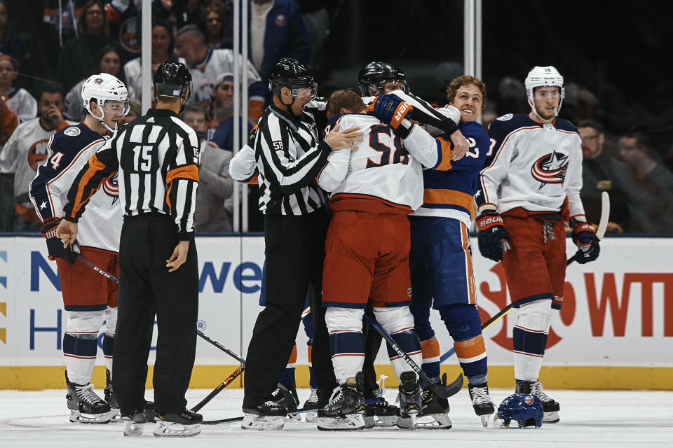 New York Islanders' Anders Lee, second from right, fights with Columbus Blue Jackets' David Savard, center, during the first period of an NHL hockey game Saturday, Dec. 1, 2018, in Uniondale, N.Y. (AP Photo/Andres Kudacki)