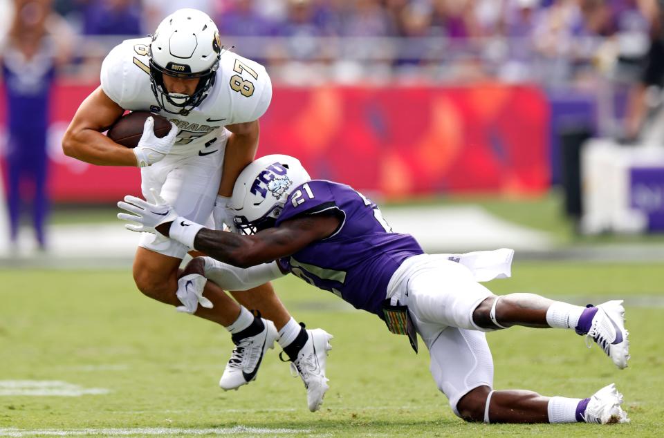 Colorado's Michael Harrison (87) is hit by TCU's Bud Clark (21) on Sept. 2, 2023, at Amon G. Carter Stadium.