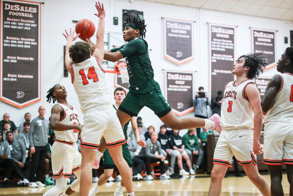 Trinity's Drae Vasser slices through the DeSales defense. Vasser scored a game-high 40 points as the Shamrocks won, 75-71, in overtime Tuesday night at DeSales High School.