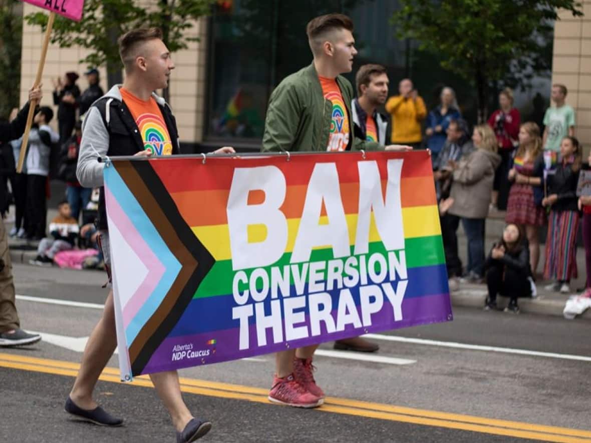 At Calgary's Pride parade in 2019 there were lots of banners calling for conversion therapy to be banned. (Michaela Neuman Photography - image credit)