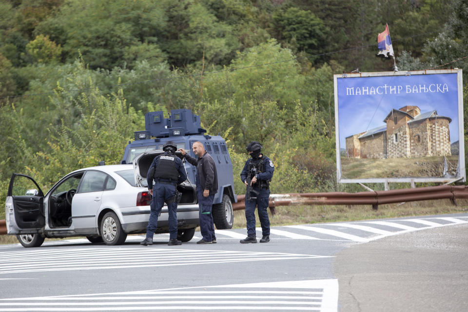 Kosovo police officers search vehicles at a cross road leading to the Banjska Monastery during a ongoing police operation in the village of Banjska on Monday, Sept.25, 2023. Kosovo on Monday observed a day of mourning for the Kosovar Albanian police officer killed by Serb gunmen who then barricaded themselves in an Orthodox monastery in a siege that further raised tensions as the two wartime foes seek to normalize ties. In the north, where most of Kosovo’s ethnic Serb minority lives in four municipalities around Mitrovica, police were patrolling in search of the armed assailants after they left the monastery. (AP Photo/Visar Kryeziu)