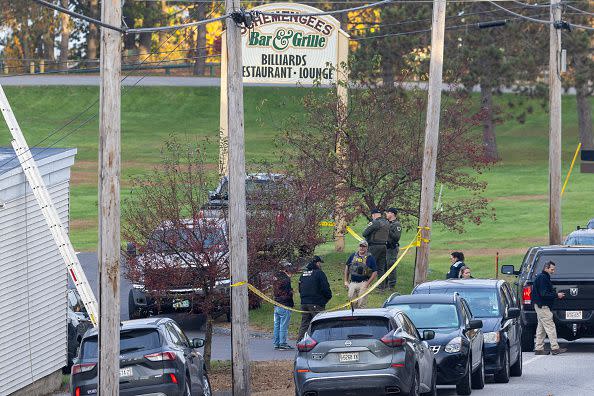 LEWISTON, MAINE - OCTOBER 26: Law enforcement officials investigate outside the Schemengees Bar and Grille on October 26, 2023 in Lewiston, Maine. Police are still searching for the suspect in the mass shooting, Robert Card.