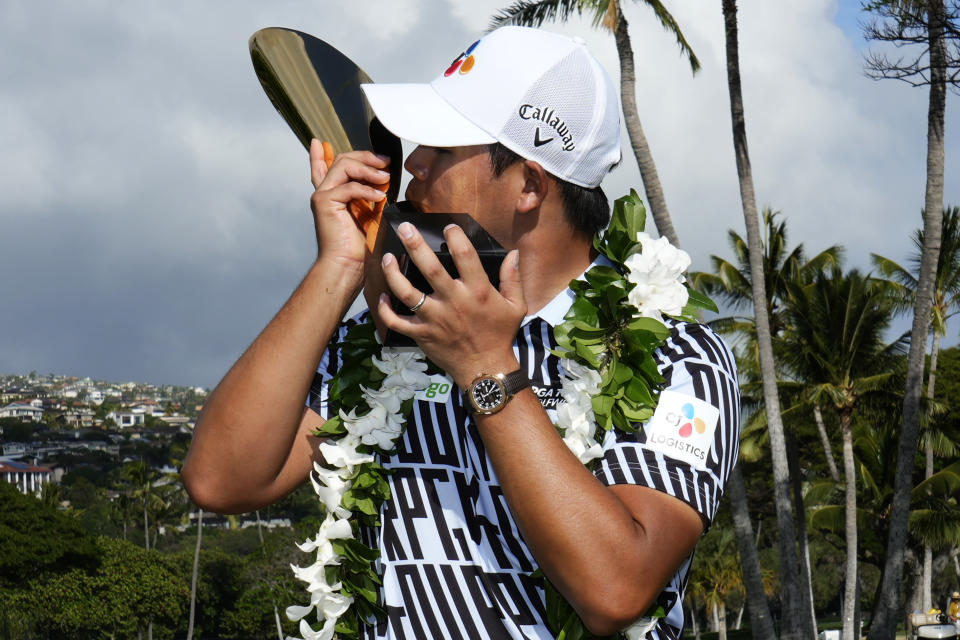 Si Woo Kim kisses the champions trophy after the final round of the Sony Open golf tournament, Sunday, Jan. 15, 2023, at Waialae Country Club in Honolulu. (AP Photo/Matt York)