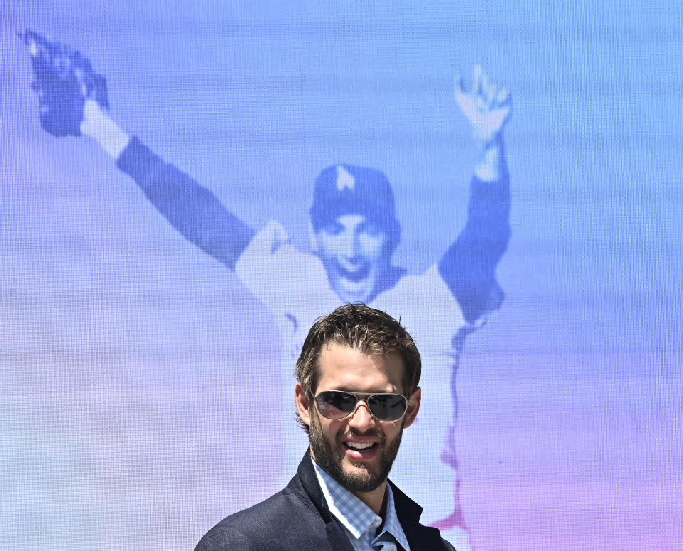 Los Angeles Dodgers pitcher Clayton Kershaw looks on with an image of Sandy Koufax in the background as the Dodgers' unveil a Sandy Koufax statue in the Centerfield Plaza to honor the Hall of Famer and three-time Cy Young Award winner prior to a baseball game between the Cleveland Guardians and the Dodgers at Dodger Stadium in Los Angeles, Saturday, June 18, 2022. (Keith Birmingham/The Orange County Register via AP)