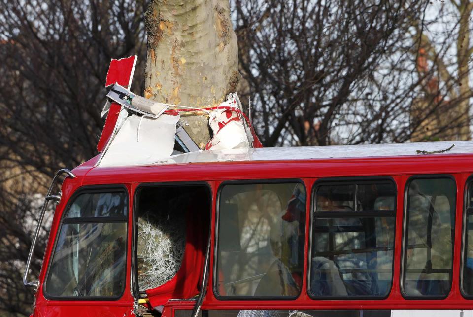 The front of the top deck a bus which crashed into a tree is crumpled by the impact in Kennington, south London