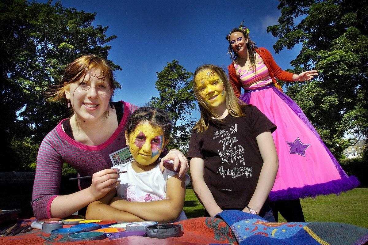 Having a good time at the Horton Park Reclaim the Park Day, 2005. L-R Katie Bootland paints the face of Hana Iamail,with Emily Connor and Sue Fee on stilts