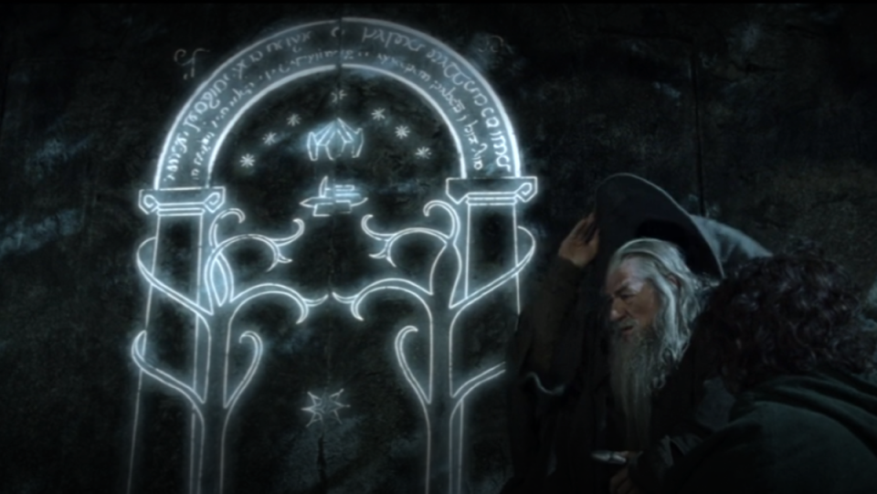 Gandalf and Frodo sit in front of the west gate or to Moria, also known as the Doors of Durin, in Fellowship of the Ring