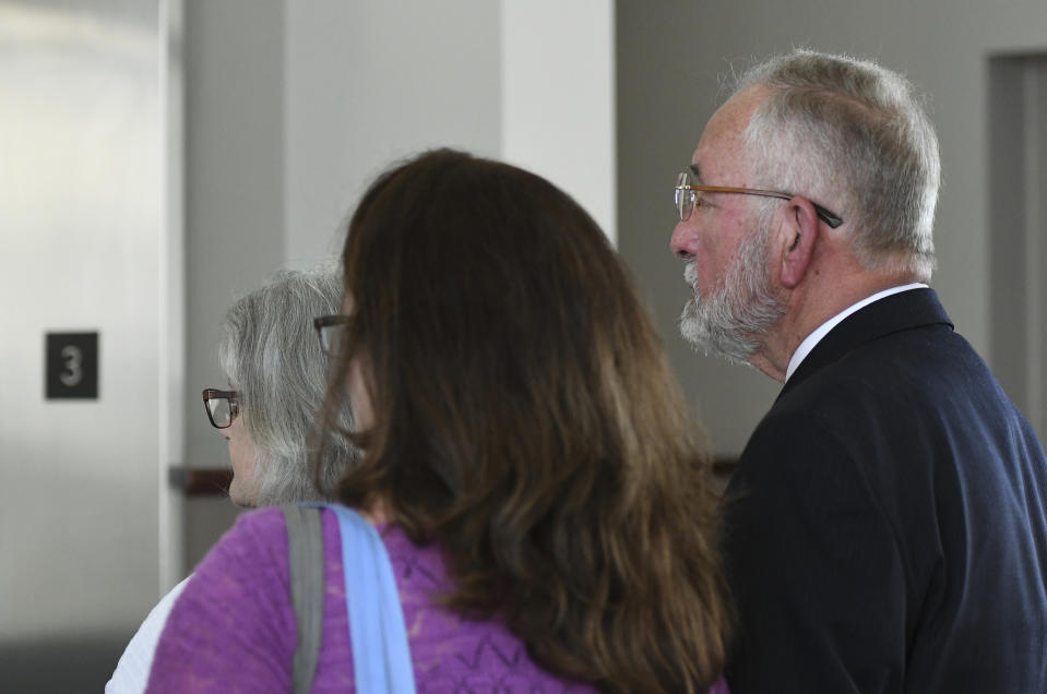 William Strampel, former dean at the College of Osteopathic Medicine at Michigan State University in East Lansing, Michigan, leaves Ingham County Circuit Court with his family, Wednesday, June 12, 2019, after a jury found him guilty of misconduct in office and two charges of willful neglect of duty related to the Nassar scandal. Strampel was found not guilty of sexual assault. (Matthew Dae Smith/Lansing State Journal via AP)