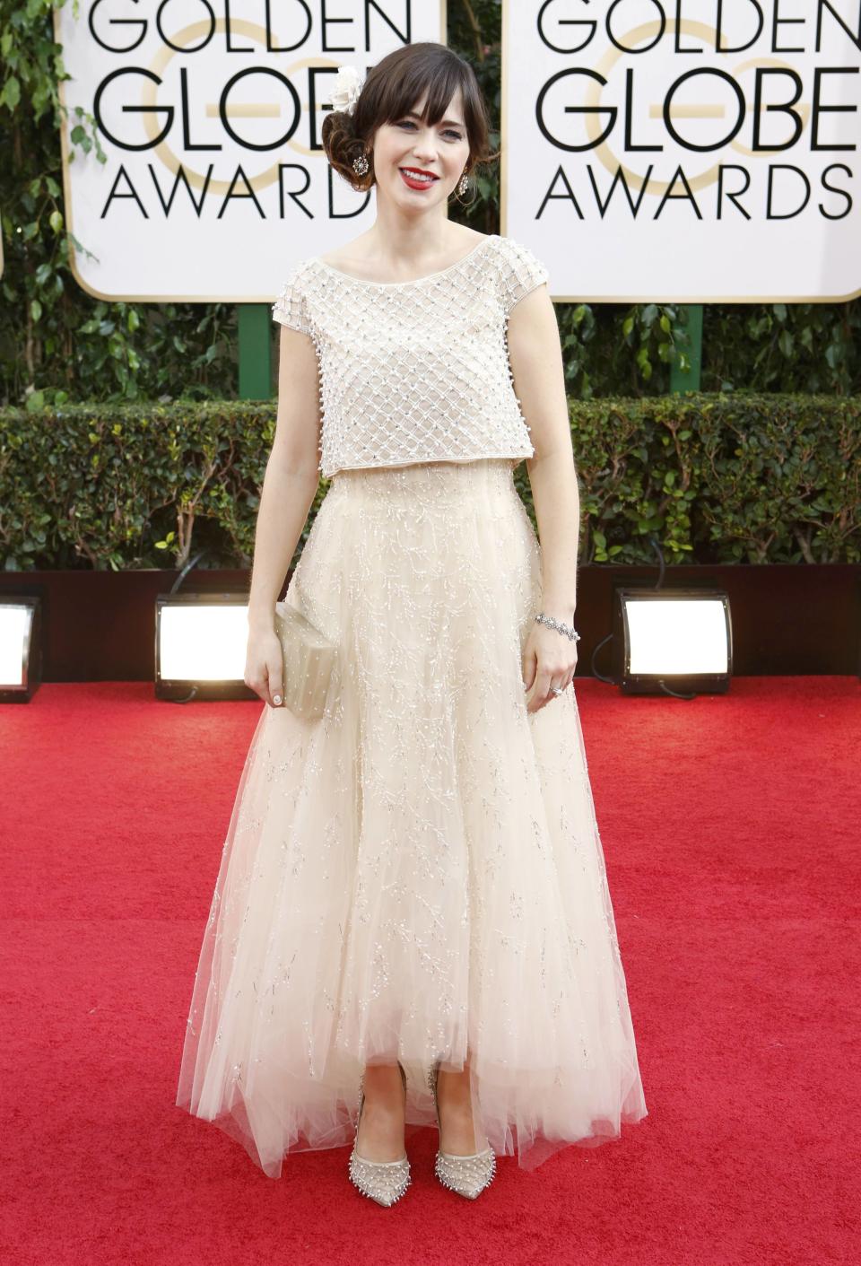 Actress Zooey Deschanel from the sitcom "New Girl" poses on arrival at the 71st annual Golden Globe Awards in Beverly Hills