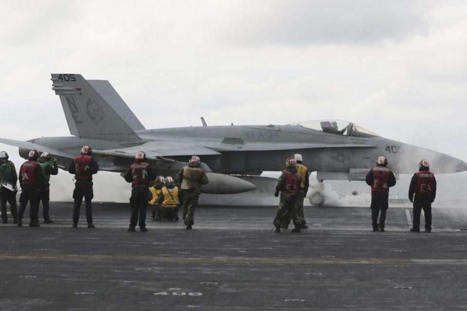 An F/A-18 fighter prepares to take off from the deck of the aircraft carrier USS Carl Vinson (AP)