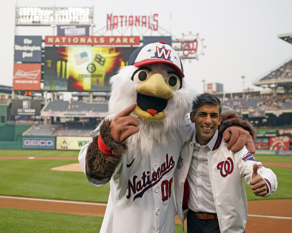 British Prime Minister Rishi Sunak poses for pictures with Screech the Washington Nationals Mascot while attending the Washington Nationals v Arizona Diamondbacks baseball at Nationals Park during his visit to Washington, Wednesday, June 7, 2023. (Niall Carson/Pool Photo via AP)