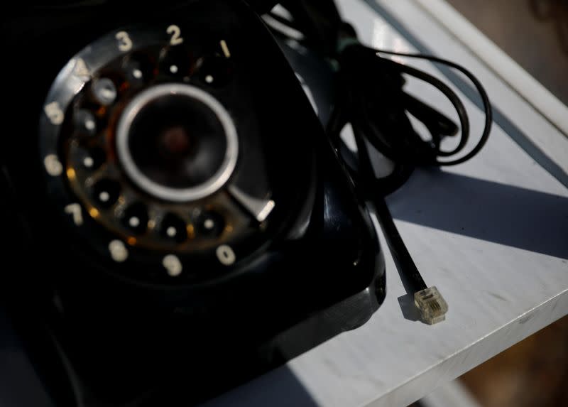 The Wider Image: Japan's tsunami survivors call lost loves on the phone of the wind