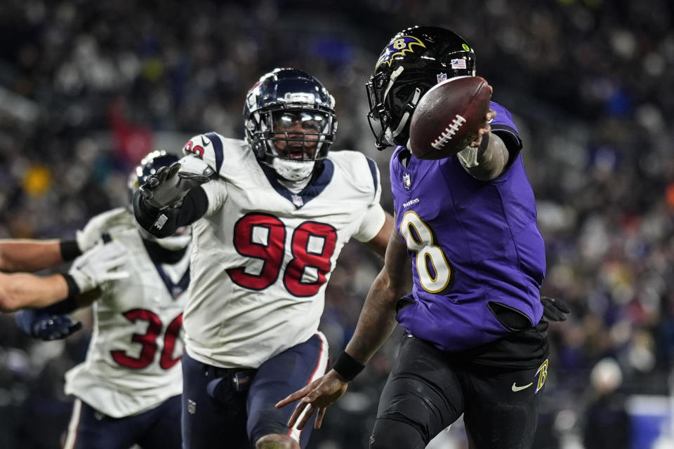 Baltimore Ravens quarterback Lamar Jackson (8) runs for a touchdown against the Houston Texans during the second half of an NFL football AFC divisional playoff game, Saturday, Jan. 20, 2024, in Baltimore. (AP Photo/Nick Wass)