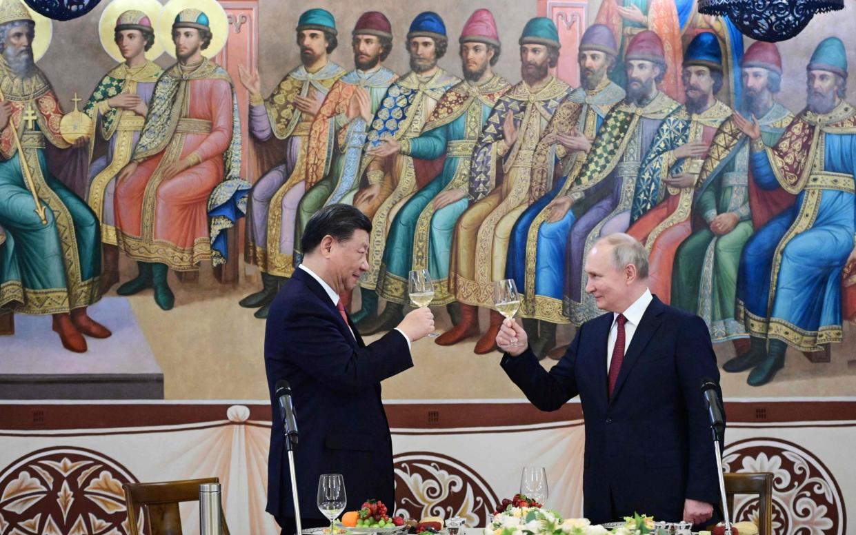 Vladimir Putin toasted President Xi Jinping with white wine at a reception - AFP