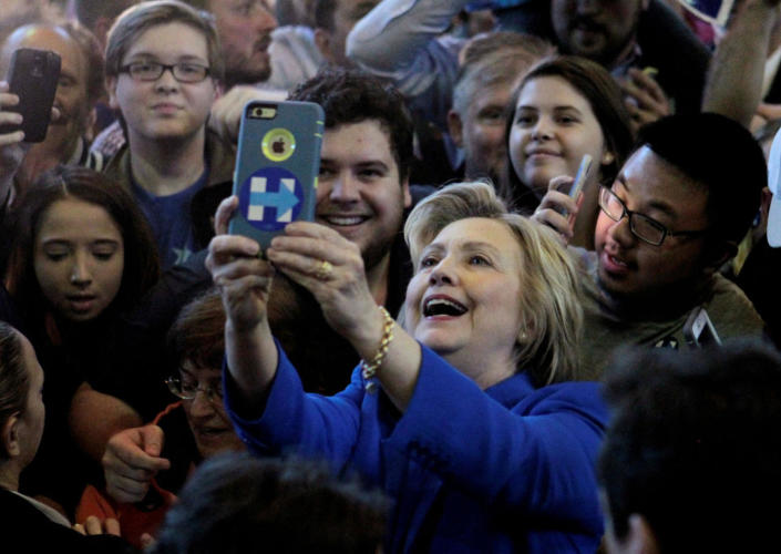 <p>U.S. Democratic presidential candidate Hillary Clinton takes photos with campaign supporters during a campaign rally at the Hall of Fame Pavilion at Louisville Slugger Filed in Louisville, Ky., May 10, 2016. (Photo: John Sommers II/Reuters)</p>