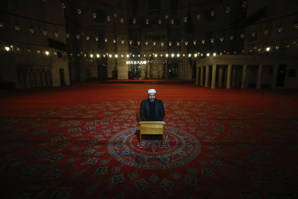 An Imam recites verses of the Qoran during the Eid al-Fitr prayer amid concerns of the coronavirus outbreak at the historical Suleymaniye Mosque in Istanbul, early Sunday, May 24, 2020. Muslims in the world are marking a muted and gloomy religious festival of Eid al-Fitr, the end of the fasting month of Ramadan _ a usually joyous three-day celebration that has been significantly toned down due to the new coronavirus outbreak.(AP Photo/Emrah Gurel)