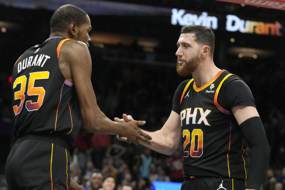 Phoenix Suns forward Kevin Durant (35) celebrates his dunk against the Milwaukee Bucks with center Jusuf Nurkic (20) during the second half of an NBA basketball game Tuesday, Feb. 6, 2024, in Phoenix. The Suns won 114-106. (AP Photo/Ross D. Franklin)