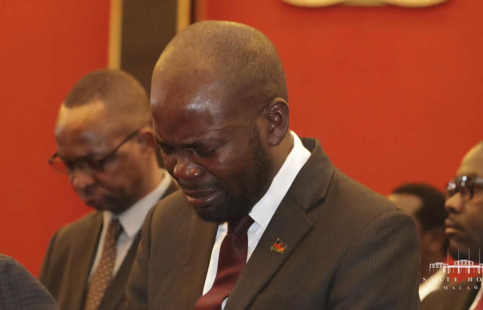 A man reacts to the Malawian President Lazarus Chakwera's news in Lilongwe, Tuesday, June 11, 2024 that the Vice President and nine others had been killed in a plane crash. The wreckage of the military plane carrying Vice President Saulos Chilima was located in a mountainous area in the north of the country after a search that lasted more than a day. (AP Photo)