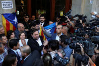 Catalan vice president Oriol Junqueras is greeted outside the Catalan region's economy ministry building during a raid by Spanish police on government offices, in Barcelona, Spain, September 20, 2017. REUTERS/Susana Vera