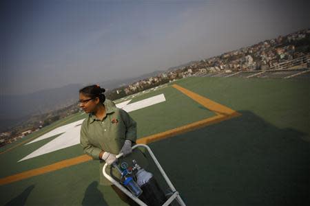 A staff member expecting the arrival of victims of a Mount Everest avalanche standbys near the helipad at Grandi International Hospital in Kathmandu April 18, 2014. REUTERS/Navesh Chitrakar