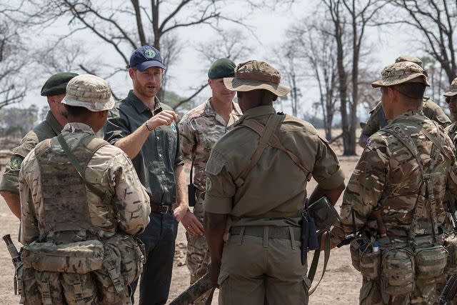 <p>AMOS GUMULIRA/AFP via Getty Images</p> Prince Harry speaks with British soldiers and Malawian game rangers at Liwonde National Park in September 2019.