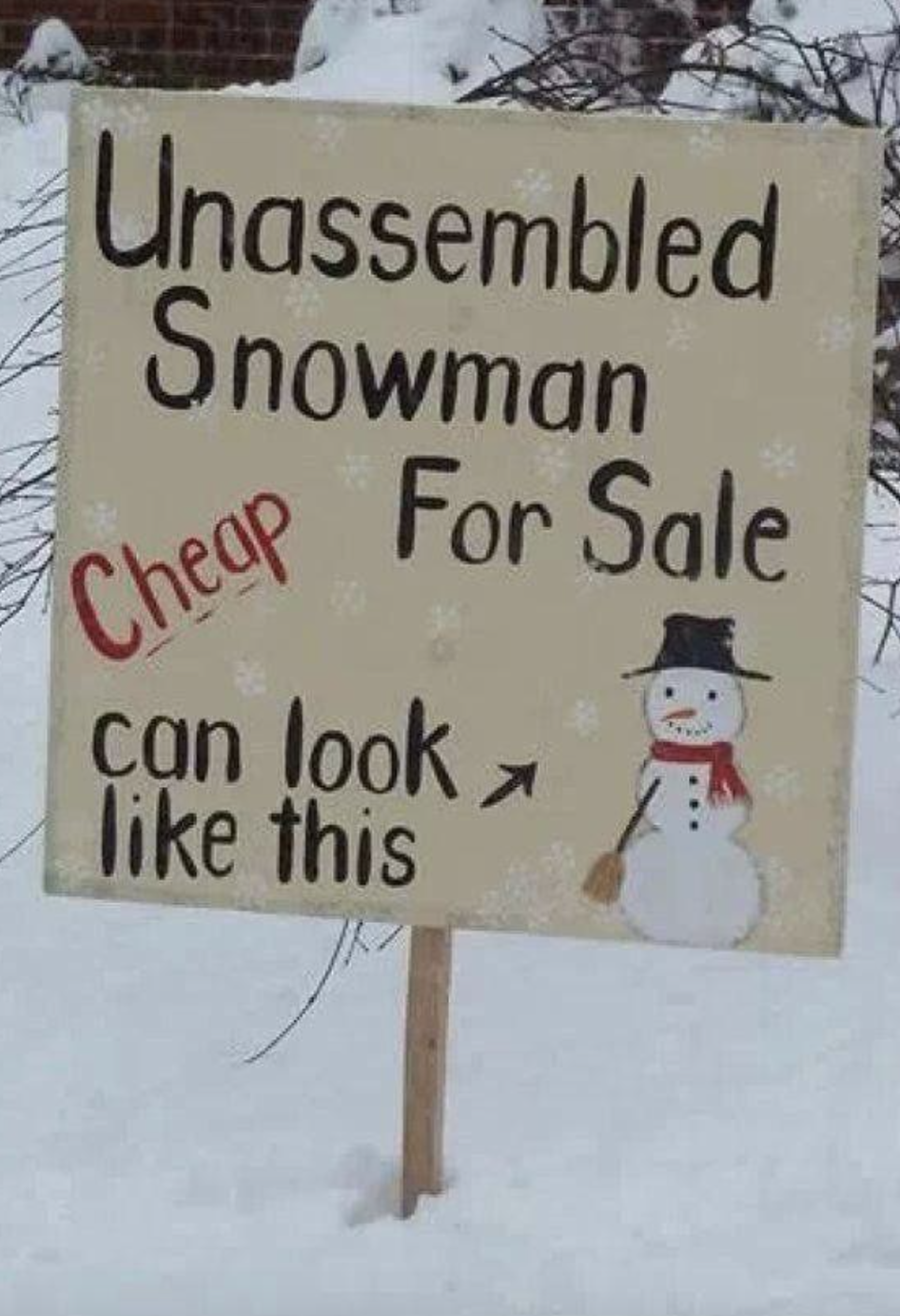 Sign reads "Unassembled Snowman for Sale" with an arrow pointing to snow and a drawing of a snowman for reference