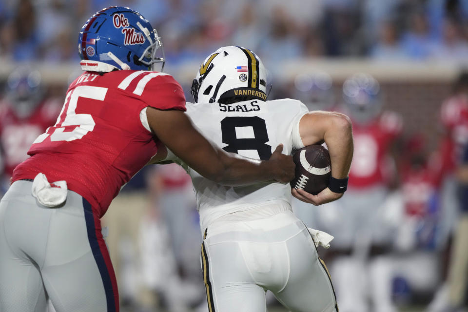 Mississippi defensive end Jared Ivey (15) sacks Vanderbilt quarterback Ken Seals (8) during the first half of an NCAA college football game in Oxford, Miss., Saturday, Oct. 28 2023. (AP Photo/Rogelio V. Solis)