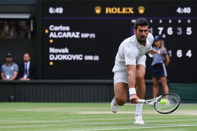 <p>ADRIAN DENNIS/AFP via Getty</p> Novak Djokovic takes on Carlos Alcaraz in the 2023 Wimbledon men's singles final.