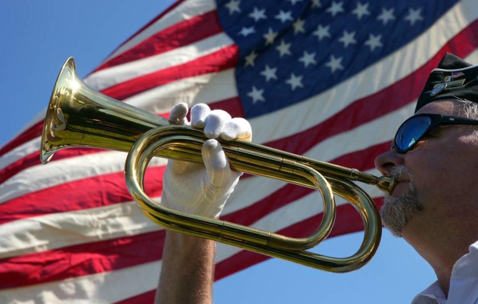 Dan Suca plays Taps during the closing of the annual Memorial Day 2011 service at the Veterans Monument on Bradenton’s riverfront.