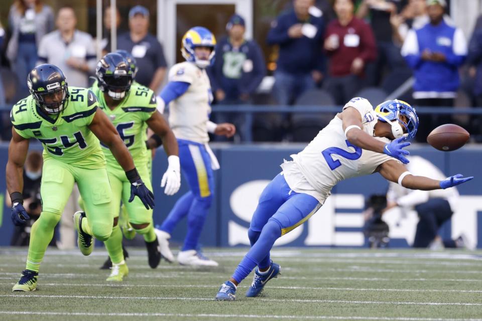 Rams wide receiver Robert Woods (2) makes a catch as Seattle Seahawks middle linebacker Bobby Wagner (54) watches.