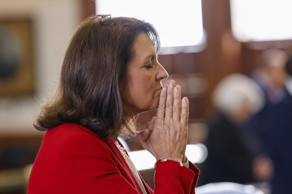 State Sen. Angela Paxton, R-McKinney, prays during the impeachment trial for Texas Attorney General Ken Paxton, her husband, in the Senate chambers at the Texas State Capitol in Austin, Texas, Tuesday, Sept. 5, 2023. (Juan Figueroa/The Dallas Morning News via AP, Pool)