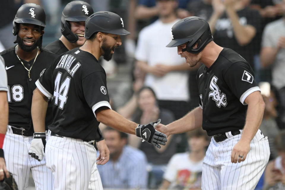 Chicago White Sox's Seby Zavala (44) celebrates at home plate with Adam Engel right, after hitting a grand slam during the fourth inning of the team's baseball game against the Cleveland Indians on Saturday, July 31, 2021, in Chicago. (AP Photo/Paul Beaty)