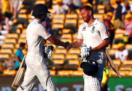 Cricket - Ashes test match - Australia v England - WACA Ground, Perth, Australia, December 14, 2017. England's Dawid Malan shakes hands with team mate Jonny Bairstow as they walk off the ground at the end of play during the first day of the third Ashes cricket test match. REUTERS/David Gray