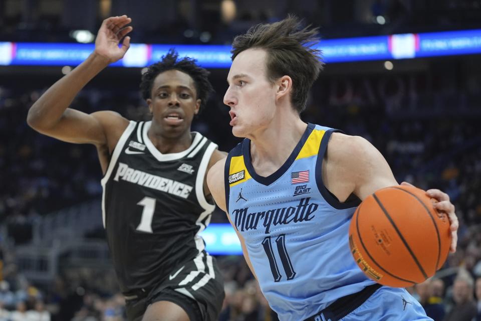 Marquette's Tyler Kolek drives past Providence's Jayden Pierre during the first half of an NCAA college basketball game Wednesday, Feb. 28, 2024, in Milwaukee. (AP Photo/Morry Gash)