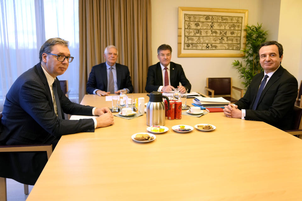 Serbian President Aleksandar Vucic, left, and Kosovo's Prime Minister Albin Kurti, right, meet with European Union foreign policy chief Josep Borrell, second left, in Brussels, Monday, Feb. 27, 2023. The leaders of Serbia and Kosovo are holding talks Monday on European Union proposals aimed at ending a long series of political crises and setting the two on the path to better relations and ultimately mutual recognition. (AP Photo/Virginia Mayo)