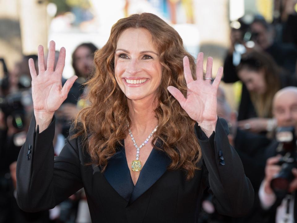 Julia Roberts with her hands up while being photographed at the 2022 Cannes Film Festival